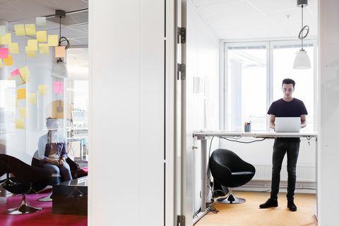 Young businessman using laptop in office